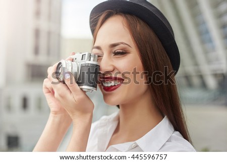 Beautiful young woman in vintage style in the hat makes the photo. Vintage style. Tourism