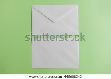 Blank envelope on green background