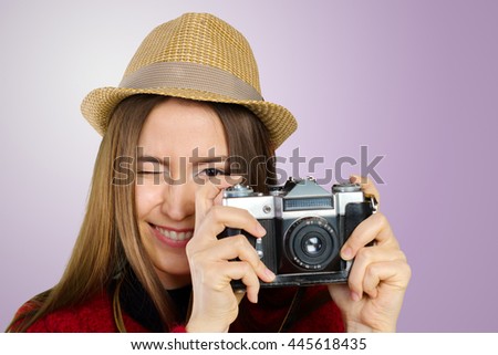 Cheerful young woman with camera 