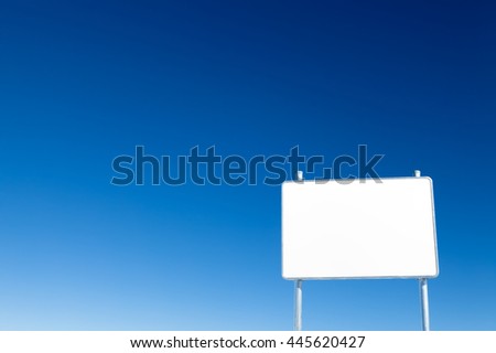 Blank white metal advertising billboard on blue sky background