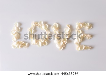 Word love made of white rose petals. Inscription from the petals of flowers. Wedding and romantic theme