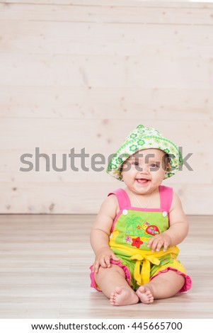 the little girl sitting in the Studio with balls