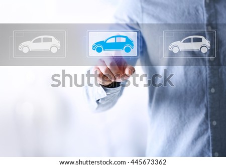 Young man touching icon of car on virtual screen