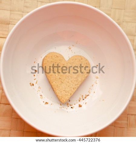 Heart cookie in a bowl with crumbs