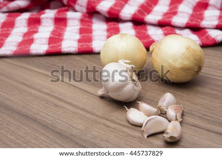 Onions and garlics on a classic kitchen background
