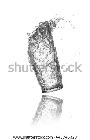 water splash out of glass on black background.