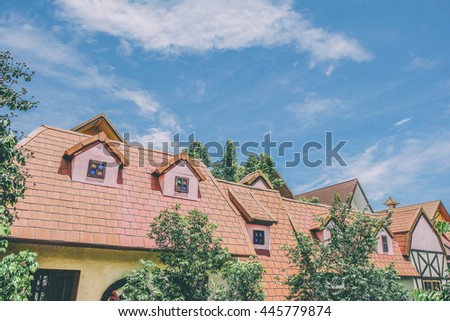 Chimney window and house roof  against blue sky. Image is vintage effect and low light photo