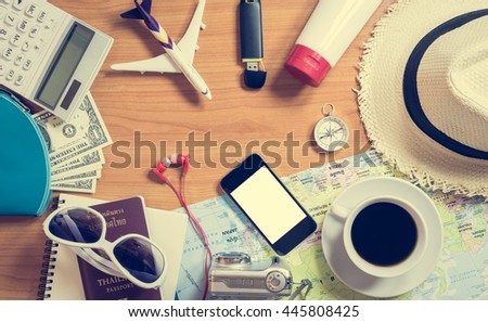Set of travel accessory and cup of coffee on wooden vintage background