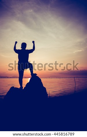 Silhouette of successful woman relax and showing arm up gesture. Action of winner. Vignette picture style.