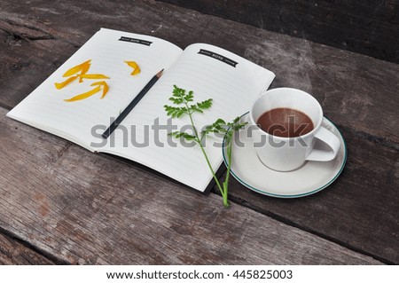 Cup of hot coffee on a wooden,