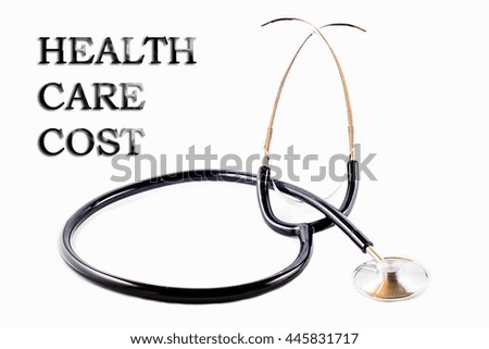 Stethoscope for doctor with words "HEALTH CARE COST" and white background
