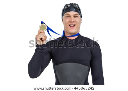 Portrait of swimmer showing his gold medal on white background