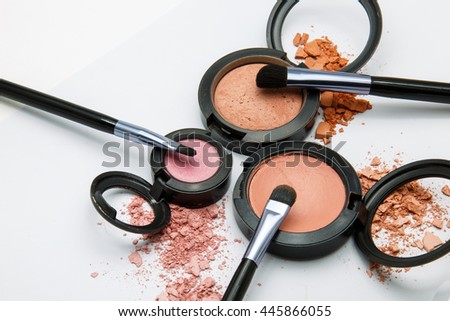 makeup powder and brush on white background