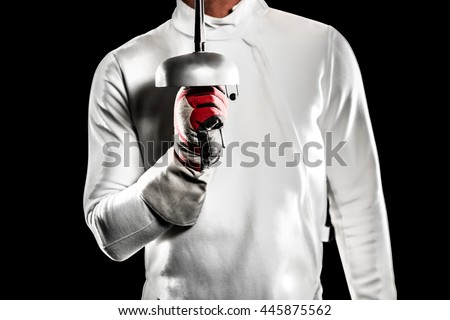 Close-up of swordsman holding fencing sword on black background Royalty-Free Stock Photo #445875562