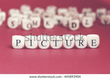 Picture word written on wood cube with red background