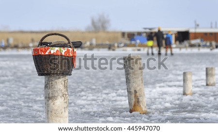 Picnic basket with shoes while skating on the lake