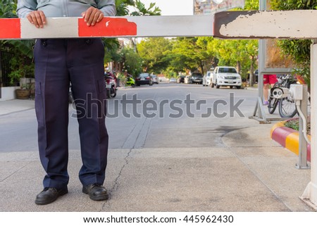 Security guard with barrier gate for access control at gateway
