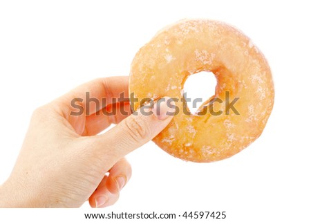 Holding a delicious donut isolated on white background with shallow depth of field