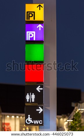 directional signs on a pole shopping center
