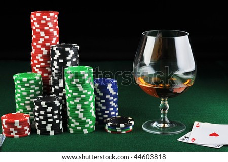  color chips for gambling, drink and playing cards on green