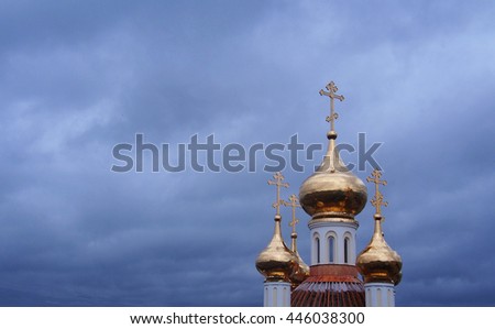 Golden domes of orthodox church and cloudy sky
