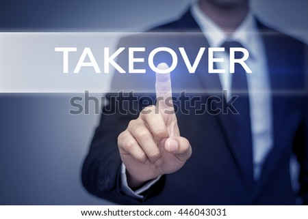 Businessman hand touching TAKEOVER  button on virtual screen Royalty-Free Stock Photo #446043031