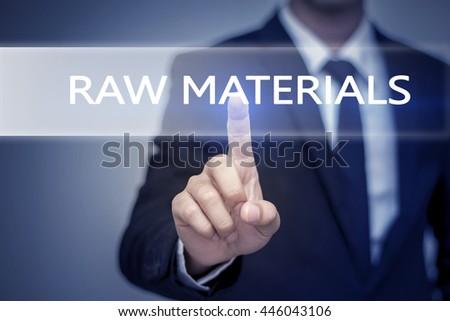 Businessman hand touching RAW MATERIALS  button on virtual screen
