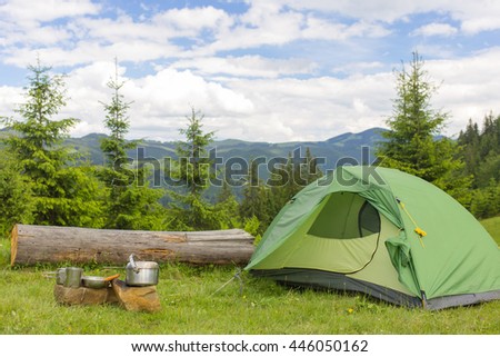 Camping in the mountains with the collected mushrooms and cooking facilities. Royalty-Free Stock Photo #446050162