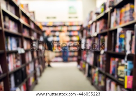 Blurred photo of a bookstore with bookshelves and shoppers. Royalty-Free Stock Photo #446055223