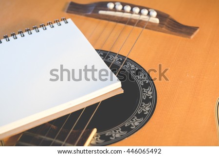 Notebook with guitar - Vintage retro picture style, Concept of music