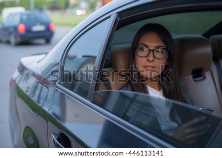 Beautiful businesswoman in car.