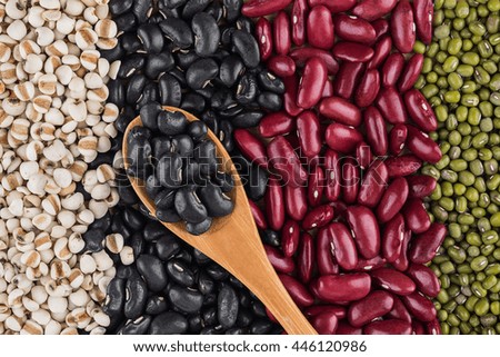 black beans in wooden spoon put on background red beans, black beans ,green beans, Millet grains
