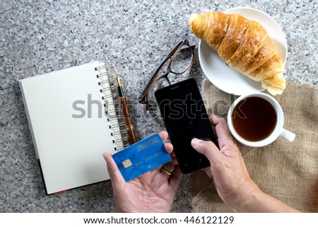 business work on marble table coffee with croissant bakery  top view