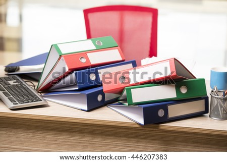 Stacks of office binders on desk