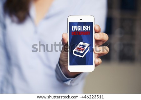 English dictionary app in a mobile phone. Woman holding smart phone.