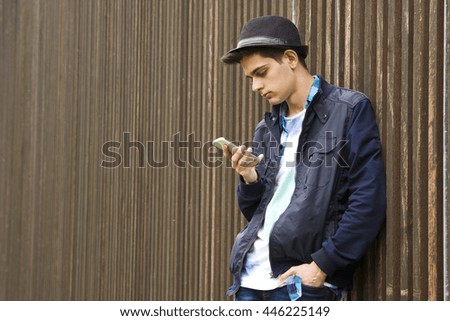 young man with the phone in the street