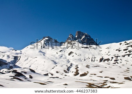 snowy peak of mountain pic du midi in mountain range of pyrenees in blue sky, south france