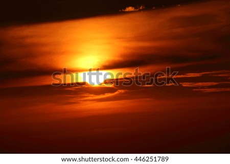 Setting summer sun against an orange sky