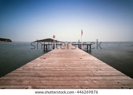 Wooden pier and island hiperfocal and long exposure picture.