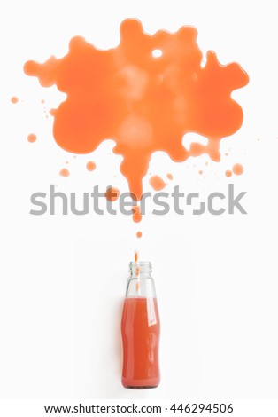 Grapefruit juice flowing or splashing out from bottle with straw. Conceptual creative flat lay citrus juice text space images.