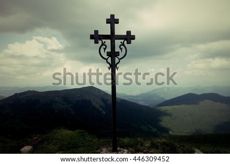 Sign of faith. Iron cross in a cloudy sky. Mount Pop Ivan, Transcarpathia