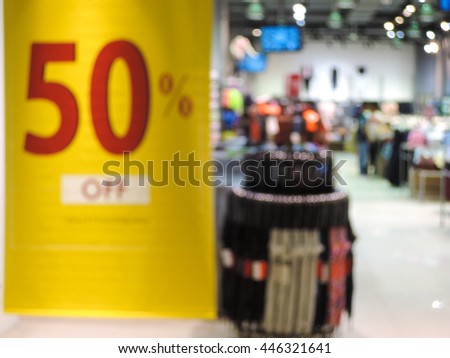 Blur image of discount signs sales store in background.
