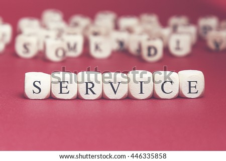 Service word written on wood cube with red background