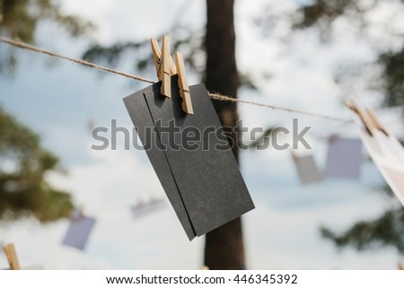 Cards hang on a rope. Conceptual background. The festival outdoors. Memory message.