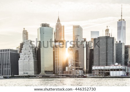 Sunburst between skyscrapers of the Manhattan skyline in New York City during sunset