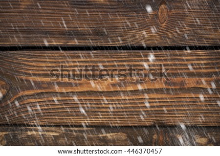 Wooden wall, snowfall - winter background or texture