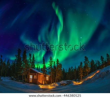 Northern lights dancing over the dream house in yellowknife Royalty-Free Stock Photo #446380525