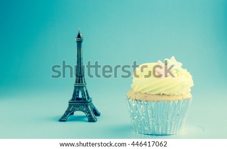 Cup cake with Eifel model vintage background