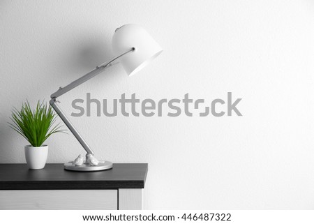 Design interior with lamp and plant on white wall background