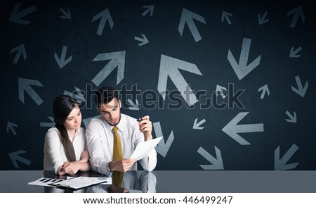 Successful business couple with arrows in background